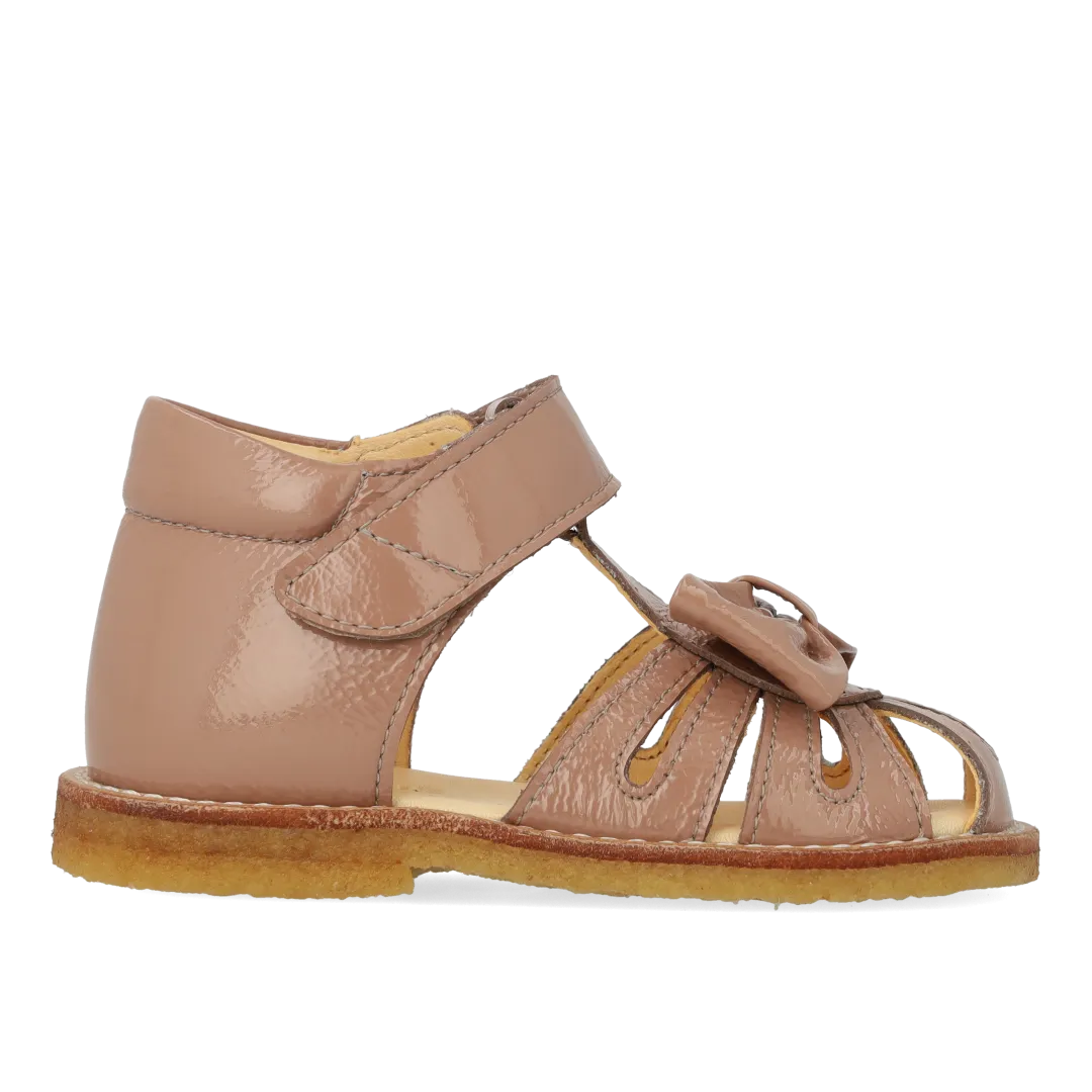 Starter sandal with a bow and velcro closure