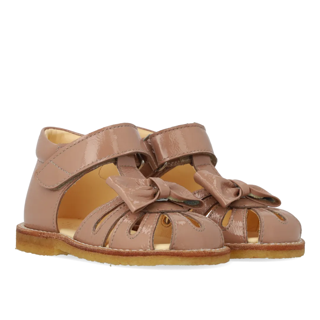 Starter sandal with a bow and velcro closure
