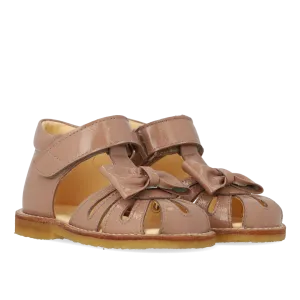 Starter sandal with a bow and velcro closure