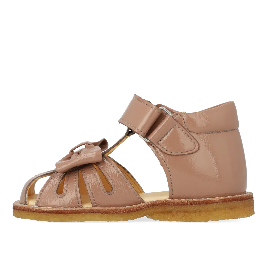 Starter sandal with a bow and velcro closure
