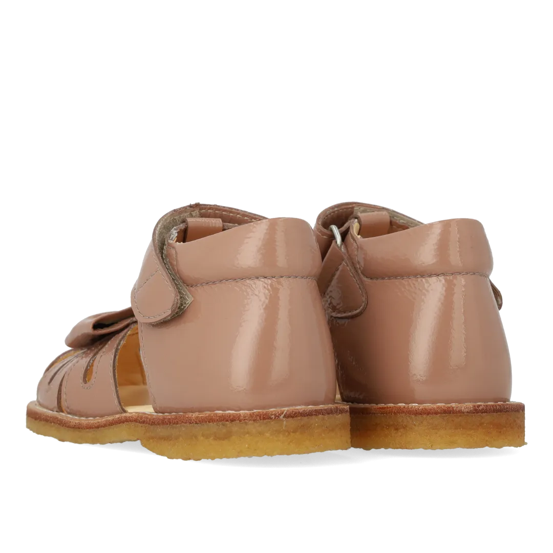 Starter sandal with a bow and velcro closure