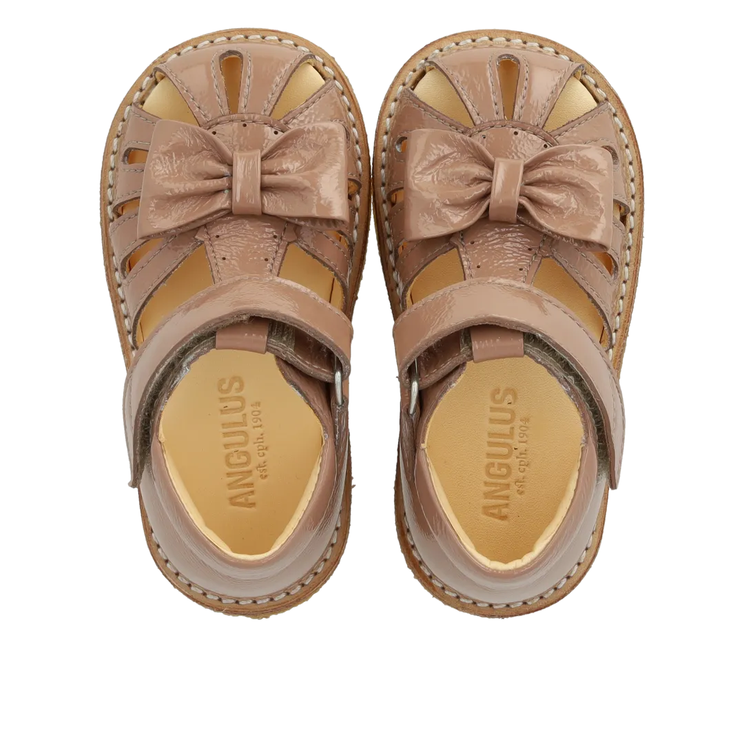 Starter sandal with a bow and velcro closure